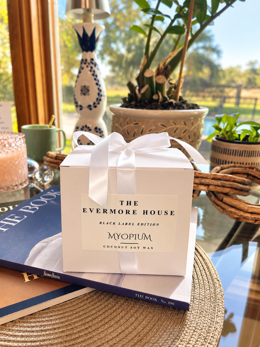 The Evermore House MYOPIUM luxury candle gift packaging featuring an elegant white gift box and white ribbon.
