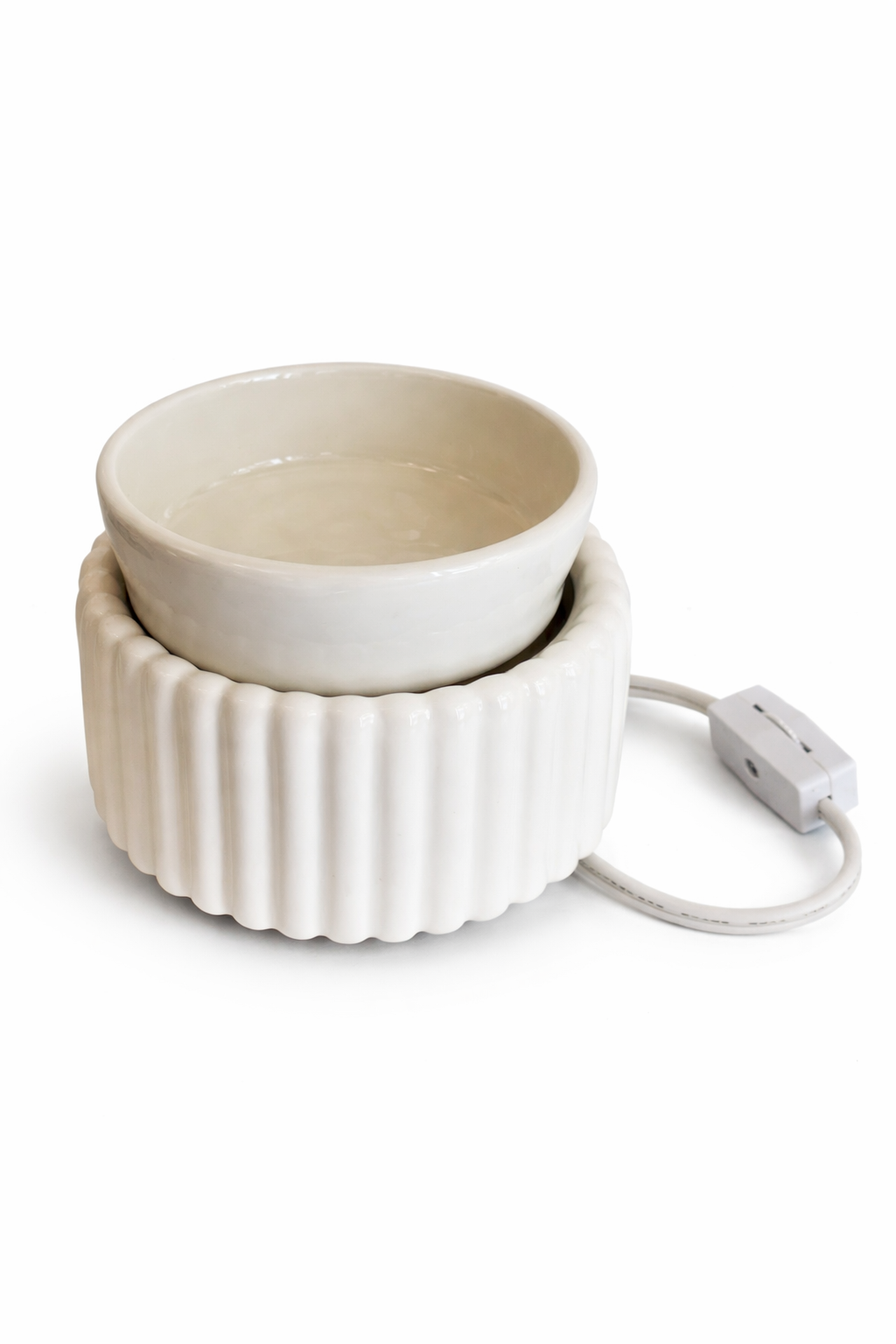 White ceramic bowl with a power adapter on a white background