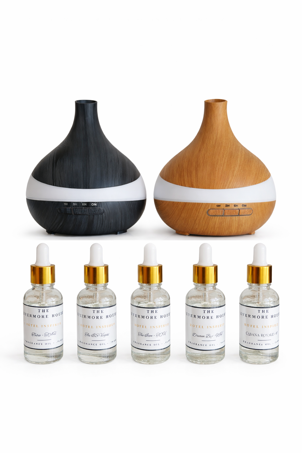 Set of essential oil bottles with gold caps and labels, and two diffusers on a white background.